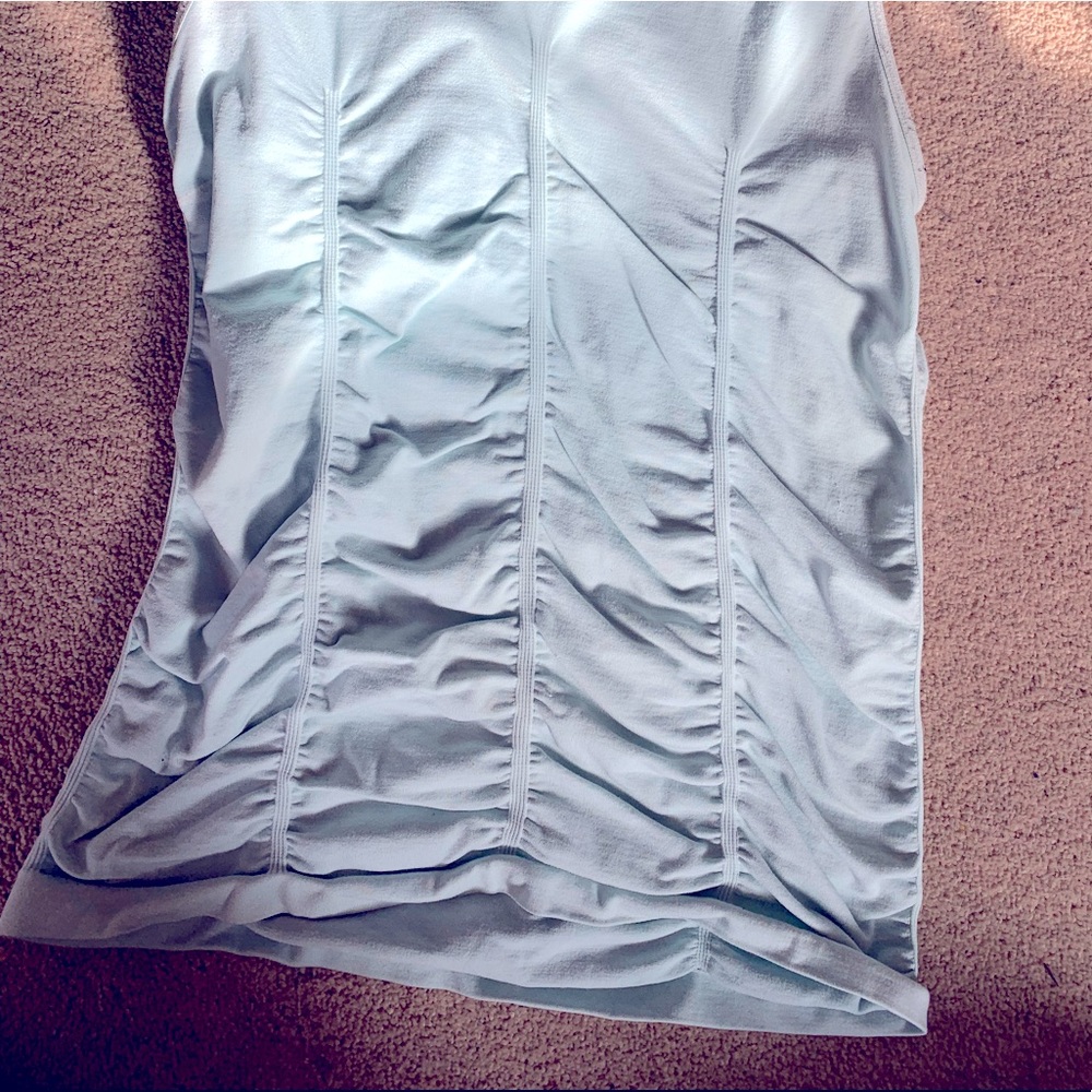 Ribbed form fitted light bluish shirt.